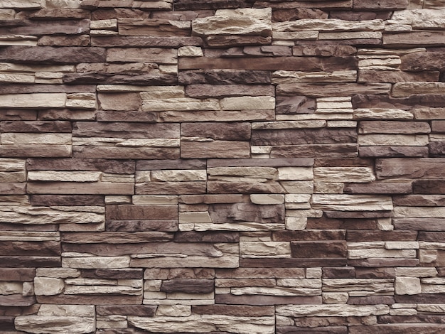 Dark beige and brown slate stone wall texture background