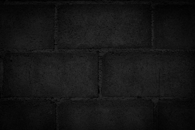 Photo dark black block wall that is not plastered