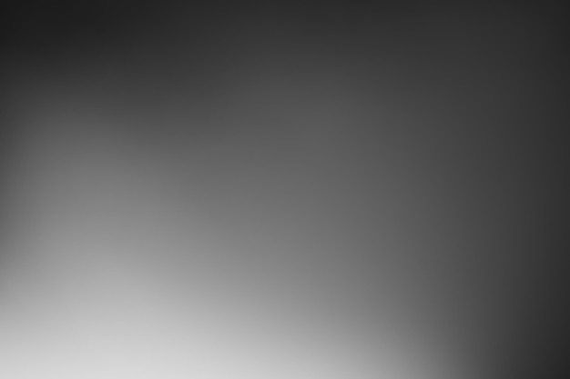 Dark black and gray blurred gradient background has a little abstract light