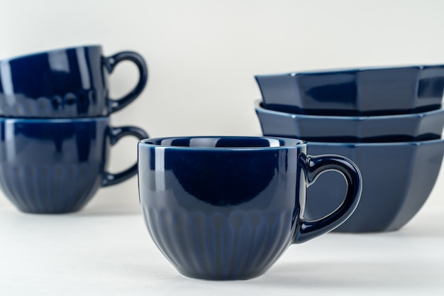 Dark blue ceramic coffee cup on table. Tableware concept