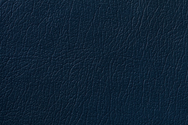 Dark blue leather texture background with pattern, closeup.