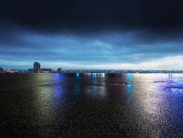 A dark blue sky with a city in the background