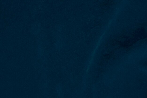 Foto tessitura di stoffa di velluto blu scuro utilizzata come sfondo stoffa denim colore seta sfondo di materiale tessile morbido e liscio velluto schiacciato lusso blu marina tono scuro per la seta