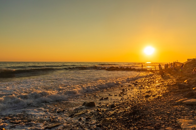 Dark blue waves against the beautiful orange sunset at the Black Sea, Anapa, Russia