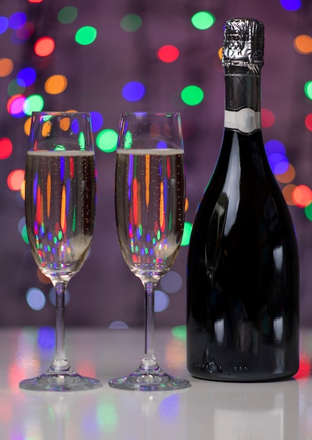 A dark bottle of wine on a beautiful festive bokeh lights