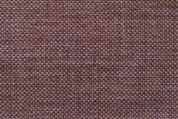 Dark brown textile background with checkered pattern, closeup. Structure of the fabric macro.