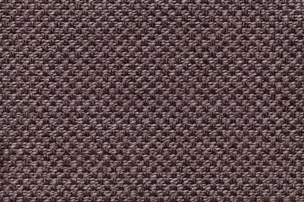 Dark brown textile background with checkered patterno.