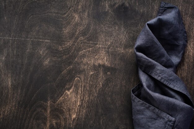 Dark brown wood texture with cotton kitchen napkin or towel