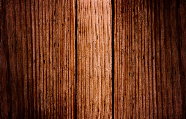 The dark brown wooden background