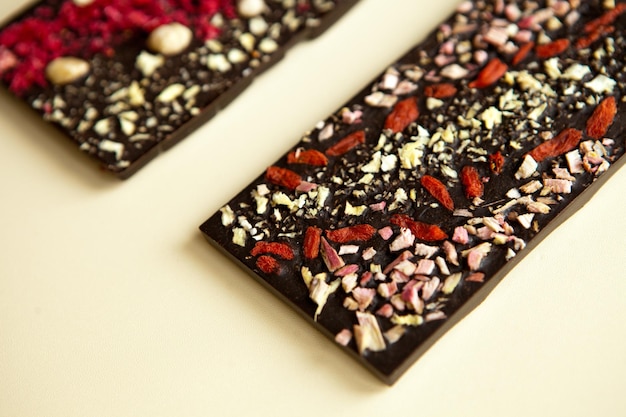 Dark chocolate bars surfaces with nuts background from top view handmade tasty dessert