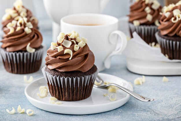 Dark chocolate cupcakes with whipped ganache frosting and white chocolate curls