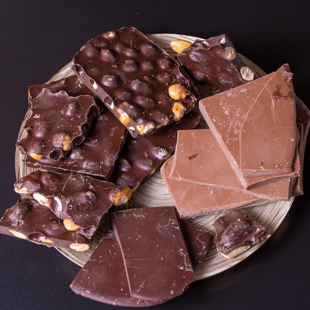 Dark chocolate layout on a wooden desk.