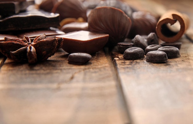 Dark chocolate pieces on a wooden table copy space