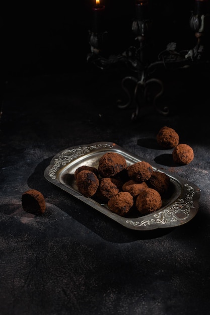 Dark chocolate truffle on dark background