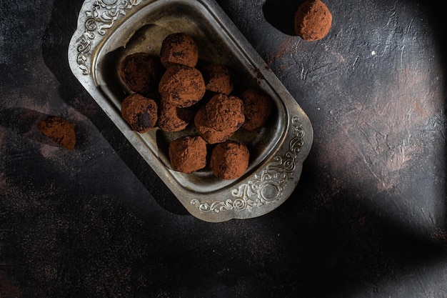 Dark chocolate truffle on dark background