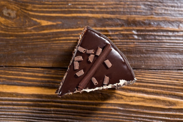 Dark chocolate vegan cake with Candied Oranges on wooden background