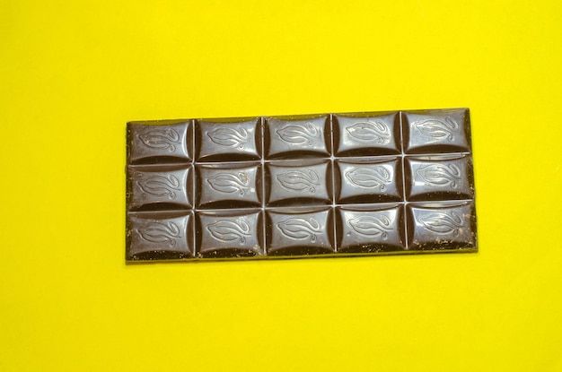 Dark chocolate on a yellow background