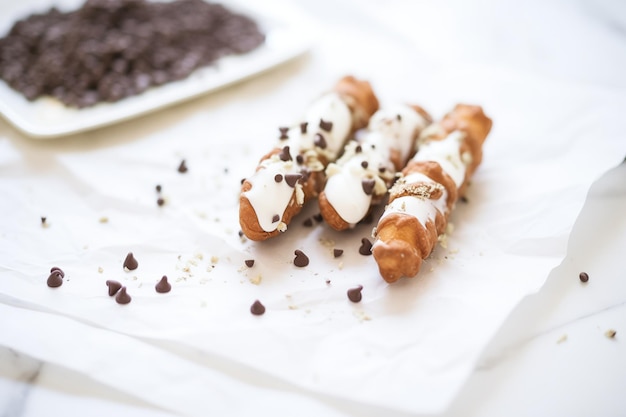 Dark chocolatedipped cannoli on white parchment