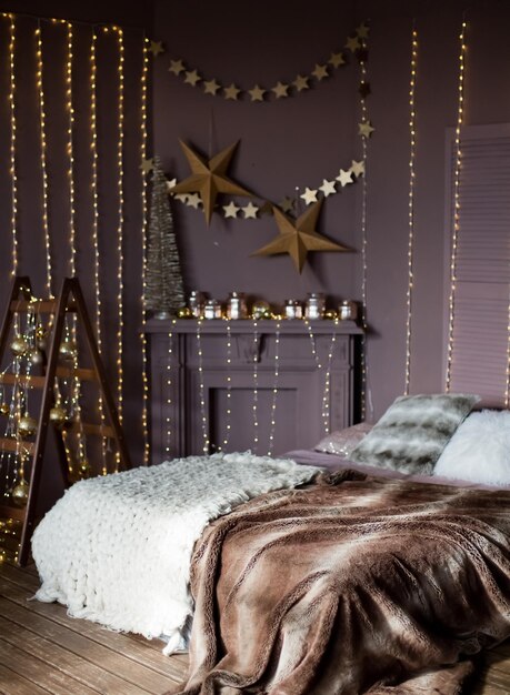 Dark Christmas interior with bed