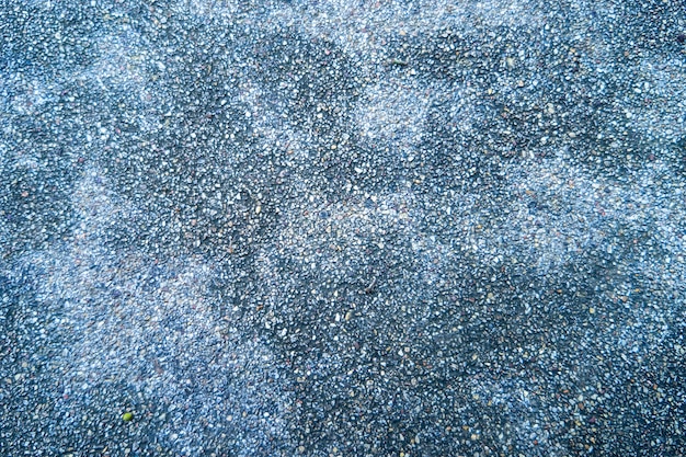 Dark concrete floor with small rock grain for use as a background.