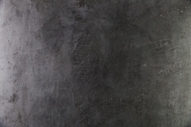 Dark concrete wall with coarse surface