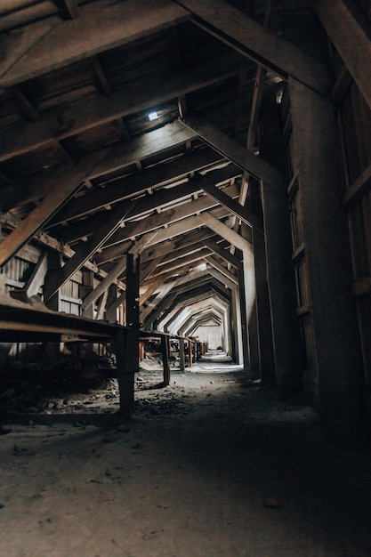 A dark and dirty looking tunnel with a light on the ceiling and a sign that says'the word'on it '