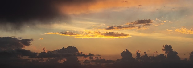 Dark dramatic sky with clouds during sunset dusk