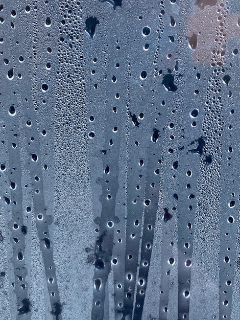 Dark drops of water on the sweaty glass. Background.