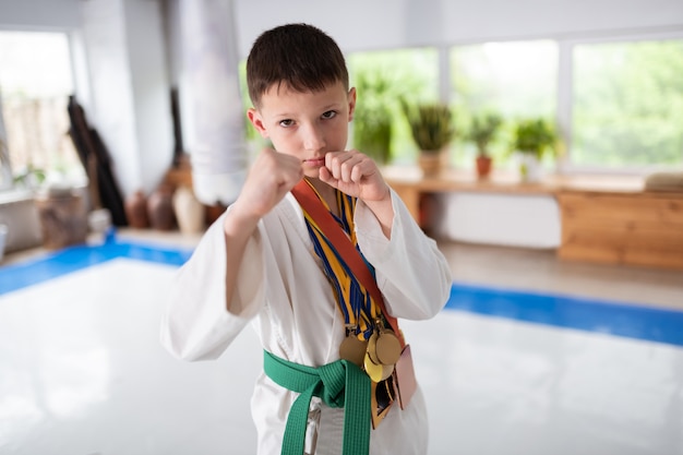 Dark-eyed boy loving aikido showing his fists