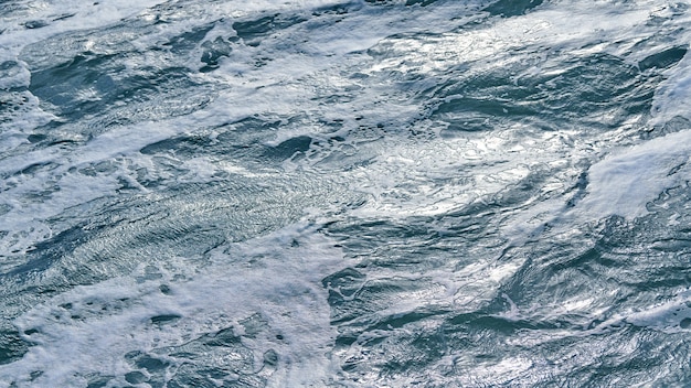 Dark foaming waves of stormy sea