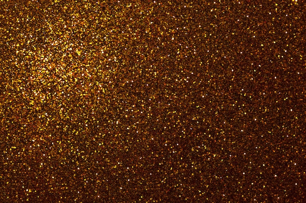 Dark golden sparkling background from small sequins,  Brilliant backdrop,