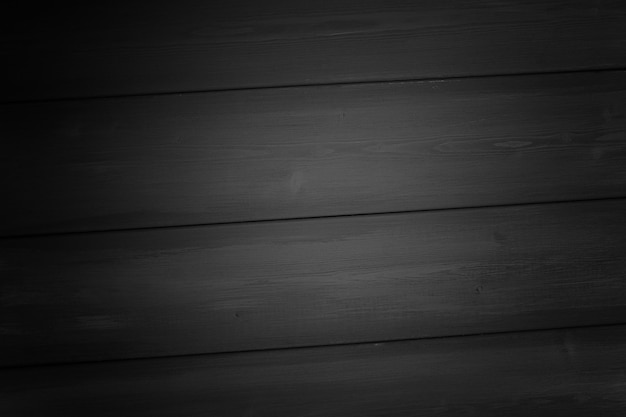 Dark gray background of wooden boards painted vignette selective focus horizontal