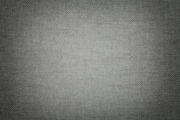 Photo dark gray from a textile material with wicker pattern, closeup.