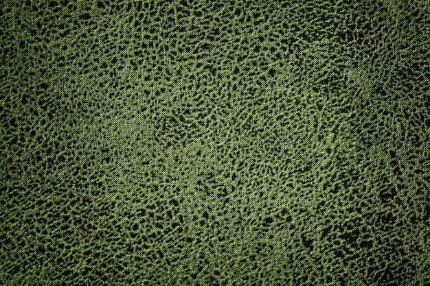 Dark green background from upholstery textile material. Olive velvet fabric texture with with vignette.