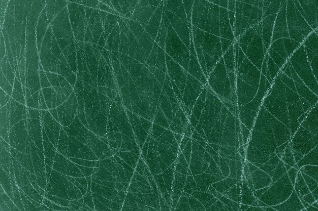 Photo dark green color rough concrete wall surface with random white scratch lines for texture background