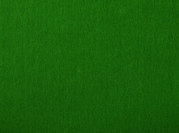 Photo dark green poker table felt soft rough textile material background texture, close up