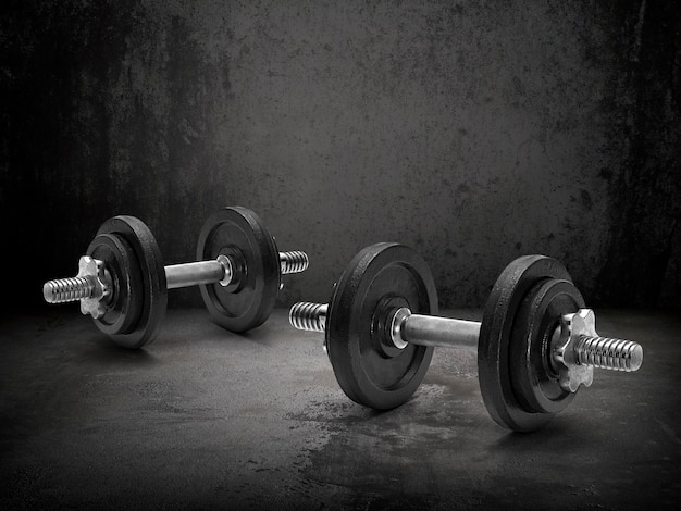 Dark gym interior with steel dumbbells