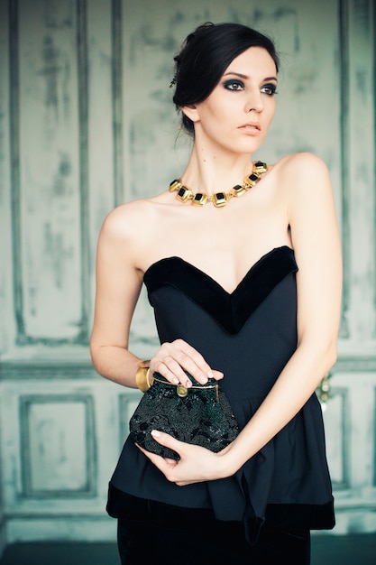 Full Length Portrait Of A Beautiful Young Woman In Long Black Dress And  Earrings And Necklace With Gems. Jewellery. Beauty, Fashion. Studio Shot.  Stock Photo, Picture and Royalty Free Image. Image 55368953.