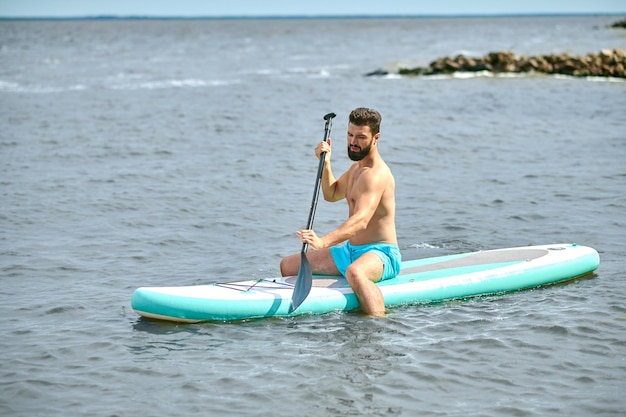 A dark-haired young man on a kayak