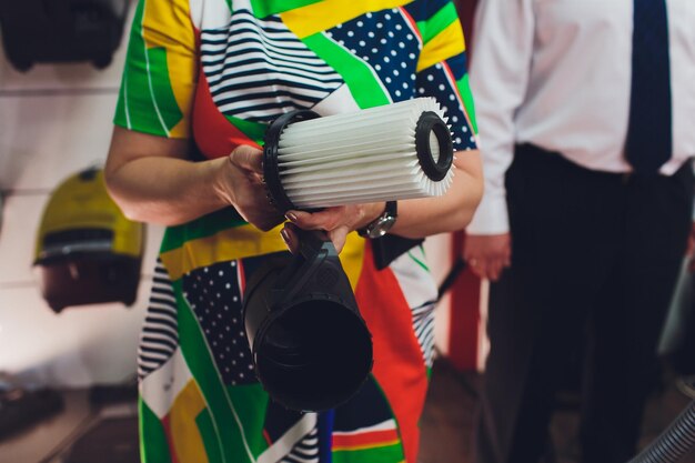 Photo dark head of a modern vacuum cleaner being used while vacuuming a rug cleaning service concept process carpet with vacuum cleaner