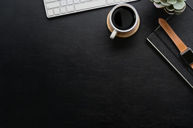 Dark leather desk with home office gadget and copy space.