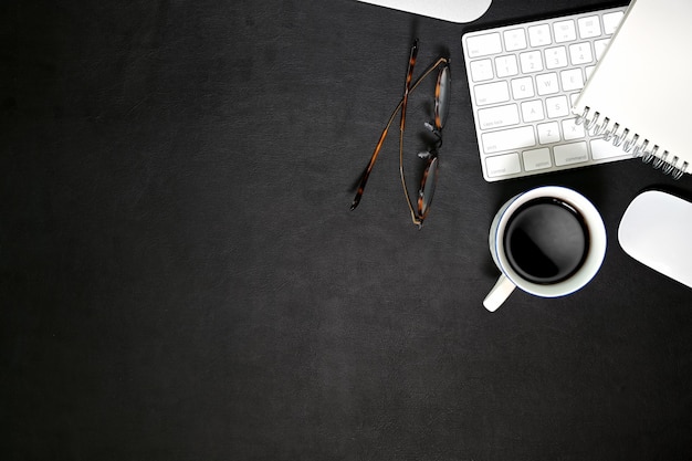 Photo dark leather workspace  and office gadget