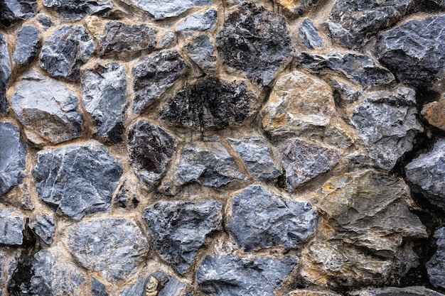 Dark masonry wall texture Black stones and rocks of different shape gray background