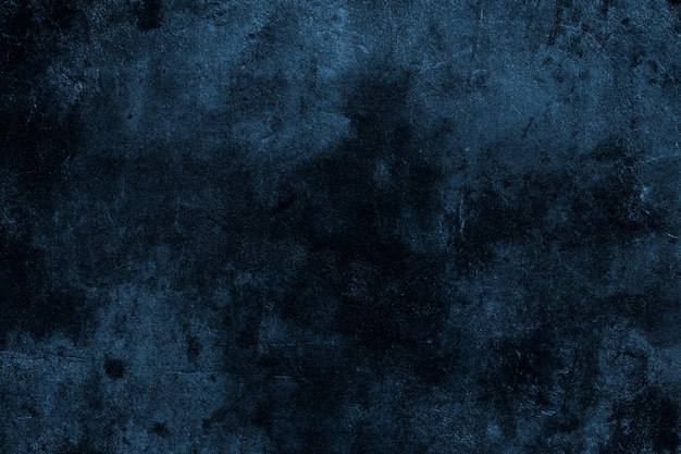 Dark moody blue color old cement plaster wall with spots and grunge textures for background