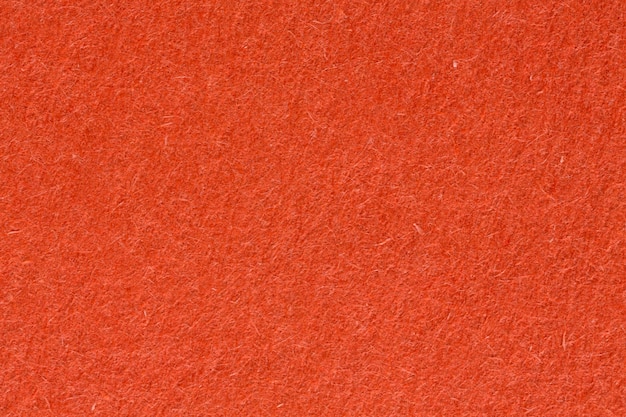 Dark orange paper texture, close up. High resolution photo.