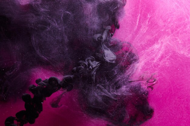 Dark Pink and black abstract ocean background Splashes drops and waves of paint under water clouds of smoke in motion