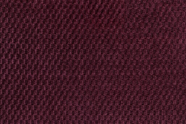 Dark purple background from soft fleecy fabric closeup. Texture of textile macro