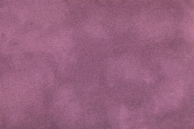 Photo dark purple matte background of suede fabric. velvet texture of seamless lilac felt textile