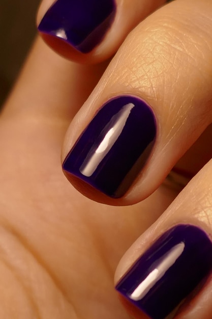 Dark purple nail design. Manicured female hand