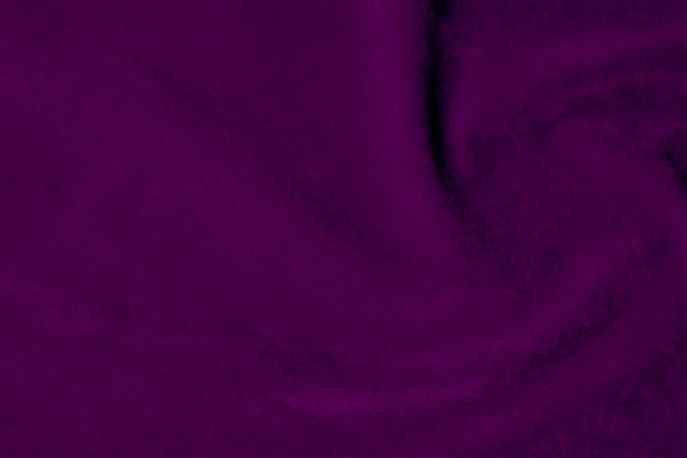 Foto tessitura di stoffa di velluto viola scuro utilizzata come sfondo colore viola stoffa viola sfondo di materiale tessile morbido e liscio velluto schiacciato lusso tono scuro per la seta